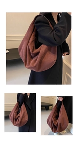 Détail d'un grand cabas minimaliste en daim rouge rouille montrant un drapé doux