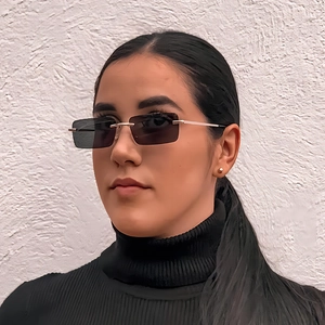 Frameless square vintage sunglasses with grey lenses and gold metal temples on female model