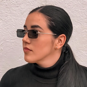 Frameless square vintage sunglasses with grey lenses and slim gold metal temples on model