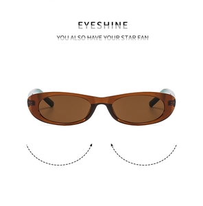 Close-up of vintage oval amber sunglasses with thick frames and dark brown lenses