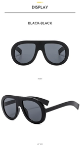 Front and side macro views of oversized black unibody sunglasses with dark lenses