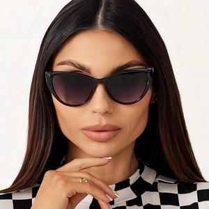 Fashionable black cat eye sunglasses with purple gradient lenses worn by a model