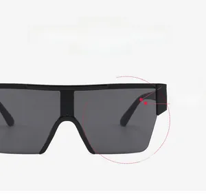 Detail of square oversized shield sunglasses with black frames and sleek seamless lenses
