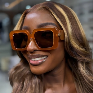 Fashionable amber square sunglasses with dark brown lenses and metal side details