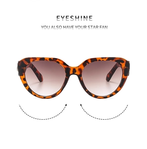 Close-up of vintage cat-eye sunglasses with tortoiseshell frames and gradient lenses