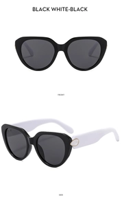 Detail view of cat eye sunglasses with shell pattern hinge and black white frame