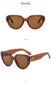 Front and side views of tea-colored cat eye sunglasses with golden leaf metal accents