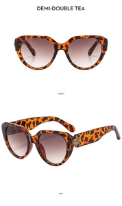 Detail view of cat eye sunglasses in demi-double tea tortoise frame with brown lenses