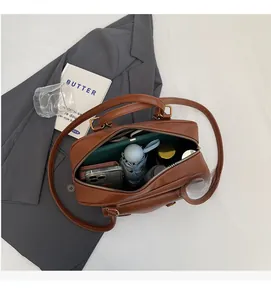Top view of brown PU leather bag interior showing capacity for umbrella and phone