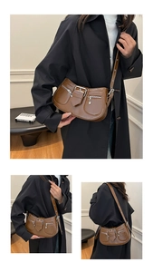 Detailansicht der braunen Vintage-Satteltasche mit Metall-Reißverschlüssen und Schnallen
