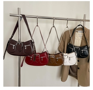 Close-up of retro motorcycle-style shoulder bags in five colors with pocket details
