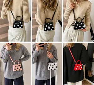 Detailed views of mini polka dot cross-body bags in multiple colors with metal locks