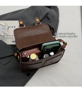 Detailed view of the spacious interior capacity of this vintage brown satchel bag