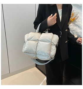 Detailed close-up of beige quilted puffer tote bag made of high-quality padded space cotton