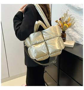 Detailed view of champagne gold quilted tote bag with metallic texture and large capacity