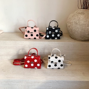 Chic polka dot crossbody handbags in pink black red and white with bow detail