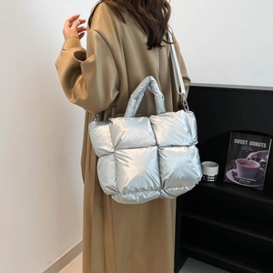 Silver quilted down tote bag with metallic finish for women, versatile crossbody style