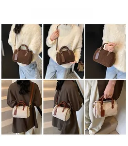 Detail view of plush Boston bag in brown and cream colors with leather straps