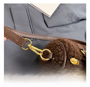 Detailed close-up of premium gold metal hooks and dark brown plush fabric texture
