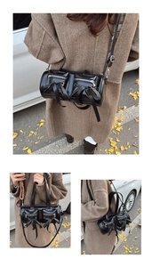 Vue détaillée du sac cylindre en cuir verni noir avec fermetures éclair et nœuds soyeux