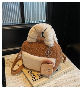 Detail of plush brown teddy bag with white faux fur pockets and cute toast charm