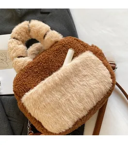 Detail view of the plush crossbody bag with a functional front pocket for small items