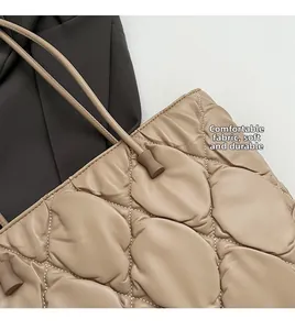 Detailed close-up of quilted puff tote fabric texture and durable soft shoulder strap