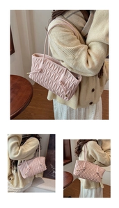 Close-up of soft pleated texture and shoulder strap detail on pink tote bag