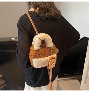 Detail of plush lamb wool shoulder bag with a cute toast pendant and leather strap
