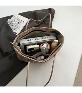 Detailed interior view of a beige quilted tote bag showing large capacity and inner pockets
