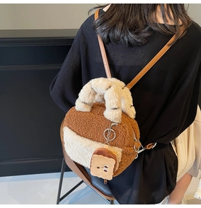 Close-up of fluffy plush backpack with two-tone faux shearling and cute bread charm