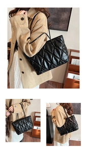 Detailed close-up of a large black quilted tote bag with soft cloud texture for women
