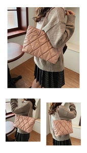 Detail view of pink quilted tote bag showing rhombus stitching and shoulder straps