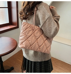 Close-up of pink quilted tote bag showing large capacity and soft nylon texture