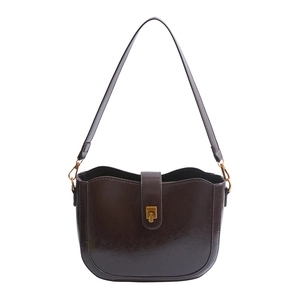 Vintage dark brown saddle bag with shiny oil-wax finish and gold rotary clasp buckle