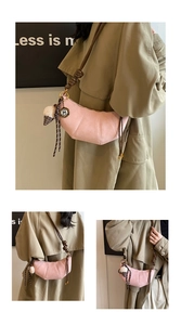 Detail of pink matte half-moon bag with decorative stitching and ice cream charm