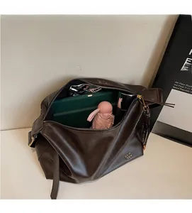 Top view of spacious deep brown tote bag interior filled with daily essentials