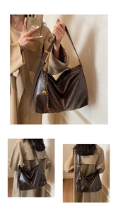 Detail view of large dark brown leather tote bag with glossy finish and gold hardware