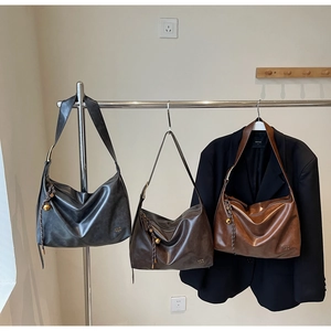 Detailed view of large vintage tote bags in three colors with gold ball charms