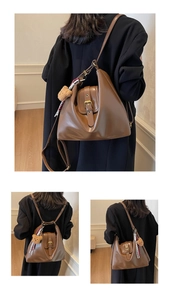 Detail of vintage brown leather bag with teddy bear charm and plaid scarf accessory