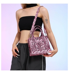 Detailed shot of pink leopard print tote bag with faux fur texture and silver hardware