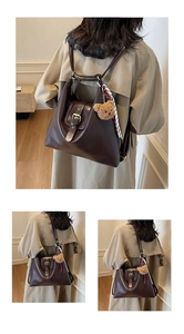 Detail of dark brown faux leather tote backpack with bear charm and ribbon decor