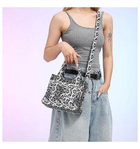 Detail view of leopard print canvas tote bag with adjustable shoulder strap for women