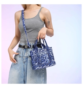 Blue leopard print tote bag with adjustable shoulder strap and stylish canvas texture