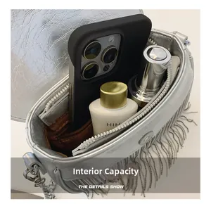 Detailed macro view of the silver PU bag interior with brown lining and a zipper pocket