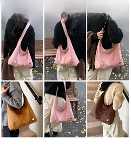 Detail shots of large suede hobo bag with oval metal buckle shown in pink and brown