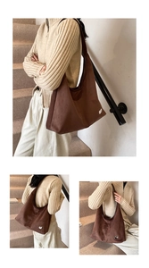 Close-up of brown suede tote bag featuring a white cat logo and soft matte texture