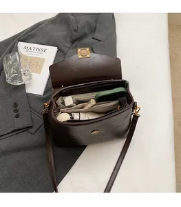 Interior view showing the storage capacity of a vintage brown leather crossbody bag