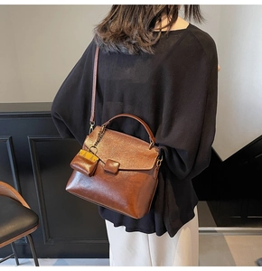 Detailed back view of a brown vintage tote bag with a matching mini charm pouch