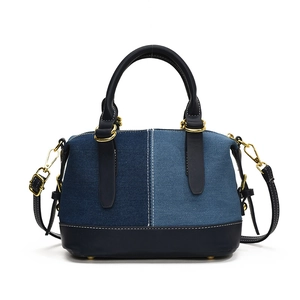Retro denim patchwork tote bag with blue leather accents and gold hardware details